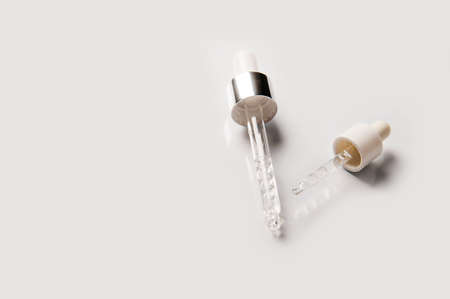 Pipette on light background close-up. Close-up of dropper for cosmetics and medicine with empty space.の写真素材