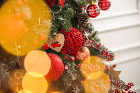 Christmas background with tree and balls, garland in defocus. New year card and copy space ...