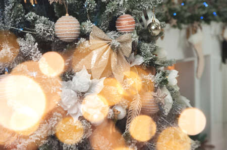Christmas background with tree and balls, garland in defocus. New year card and copy space.