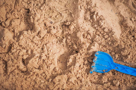 Children's blue toy on the sand and copy space.の写真素材