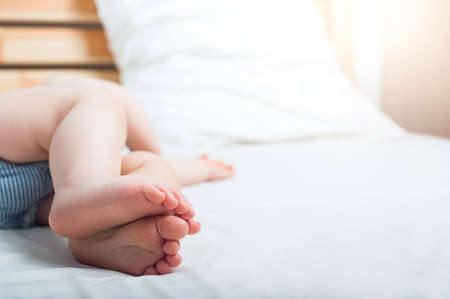Sleeping baby feet close up. Infant restful sleep, teething, colic.