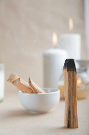 Palo Santo bars close-up and copy space. Ritual cleansing with sacred ibiocai, meditation, aromatherapy with incense and candles.の写真素材