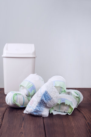Diapers waste, dirty diapers in garbage pail Disposing of used baby nappies. Environmental Impact of Disposable Diapers. Pollution of the environment, soil and waterの写真素材