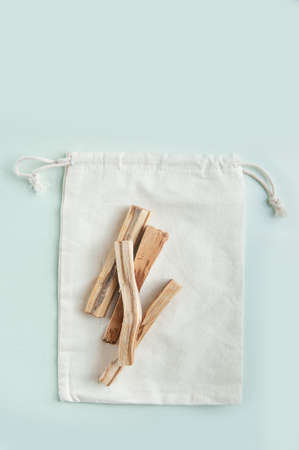 Palo Santo bars in eco bag close-up and copy space. Ritual cleansing with sacred ibiocai, meditation, aromatherapy with incense and candles.の写真素材
