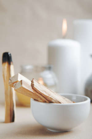 Palo Santo bars close-up and copy space. Ritual cleansing with sacred ibiocai, meditation, aromatherapy with incense and candles.の写真素材