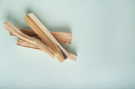 Palo Santo bars close-up and copy space. Ritual cleansing with sacred ibiocai, meditation, aromatherapy with incense and candles.の写真素材