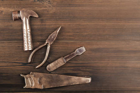 Handmade chocolate tools on wooden textured background close-up and copy space.