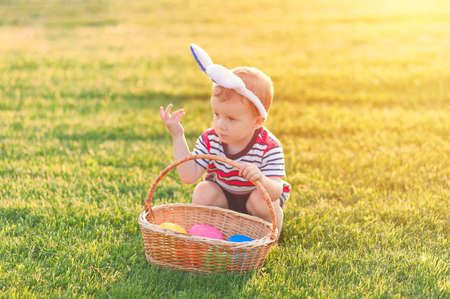 Toddler eggs hunters close-up. Children activity for Easter in nature.