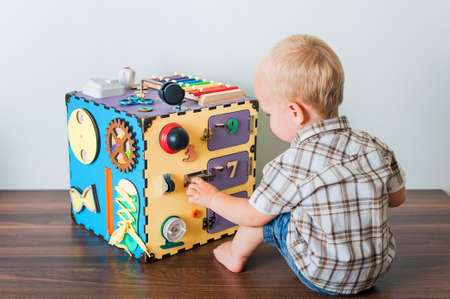 Child plays with busy board close-up ..の写真素材