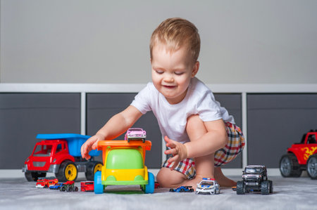 Toddler boy plays in playroom with educational toys.の写真素材