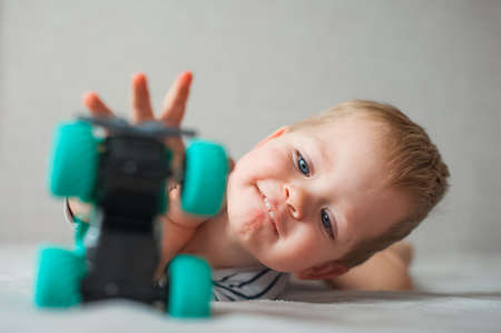 Funny toddler boy playing with toy carの写真素材