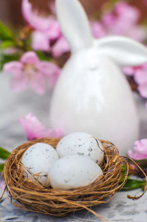 Spring blossom, Easter concept, miniature bunny, flowering tree close-up and copy space. Pink...