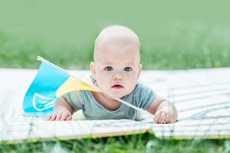 Cute baby 5 months old with flag of Ukraine close-up.の写真素材