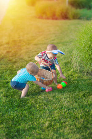 Toddler eggs hunters close-up. Children activity for Easter in nature..の写真素材