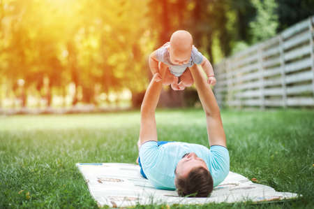 Happy Fathers Day. Young father and child on grass.の写真素材