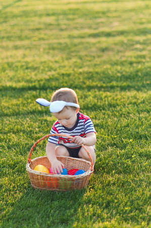 Toddler eggs hunters close-up. Children activity for Easter in nature.の写真素材