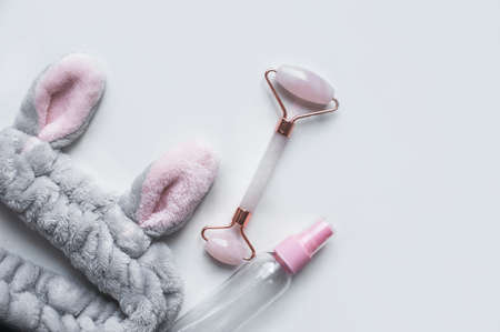 Roller marble facial massagers on white background.