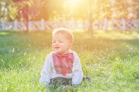Toddler boy in Ukrainian vyshyvanka in summer.