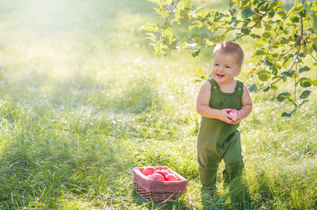 Yummy watermelon and little funny toddler in nature. First feeding of child with watermelon.の写真素材