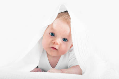 Newborn in white towel close up. baby care concept.
