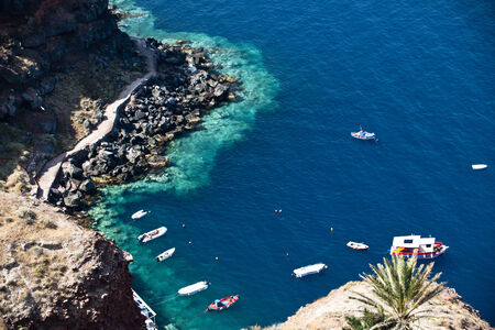 Deep blue Aegean Sea with clear water and colourful boatの写真素材