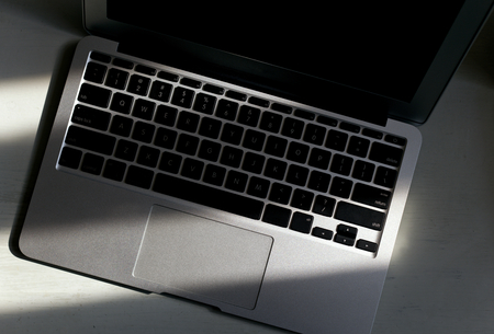 Focus on Macbook Air keyboard with sunlight shine onの写真素材