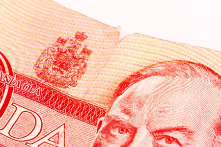 Battered Dollar.  Macro of Canadian fifty dollar bill with tear and dirty smudges.  Dirty, used  Canadian money that has taken a battering in the world market.の写真素材