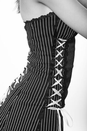 Fashion detail in black & white.  Pinstriped dress with back and sides laced in white ribbon.
