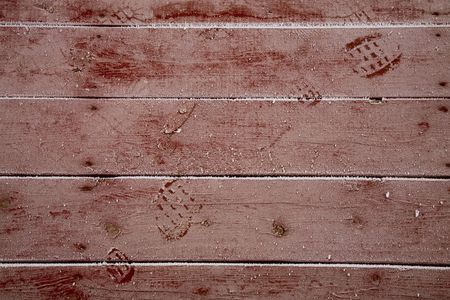 A layer of frost covers a wooden deck, accentuating every knot and footprint.の写真素材