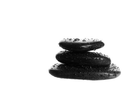 Zen massage stones with water droplets.  Shot on white background.の写真素材