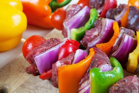 Three freshly prepared beef shish-ka-bob with vegetables, marinated and ready for the grill.   Shallow depth of field.の写真素材