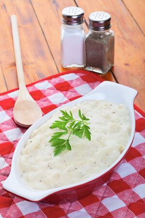 Creamy scalloped potatoes garnished with Italian parsley.の写真素材