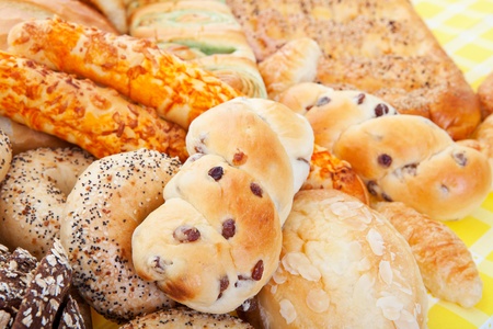 A group of international breads, including Almond Bun, Buko Pandan Loaf,  Italian Cheese Sticks,   Pumpernickel  の写真素材