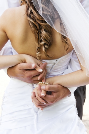 Wedding couple holding hands and hugging.の写真素材