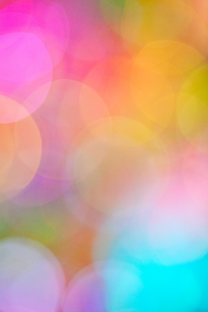 A soft, dreamy bokeh background in a blend of fuchsia, pink, blue, yellow, green, & mauve.の写真素材