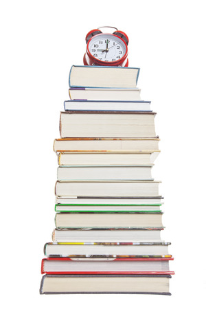 Clock on a stack of text books.  Shot on white background.の写真素材