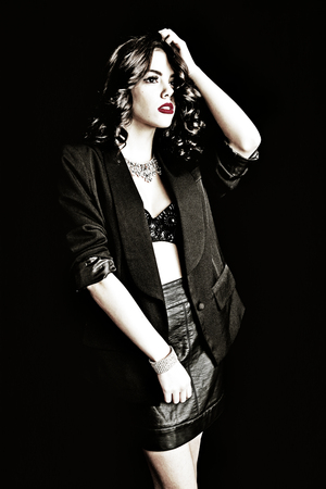 Beautiful lady with movie style glam girl fashion look.  Shot on black background.の写真素材