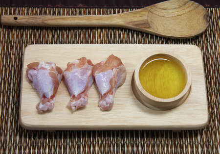 raw chicken on wooden boardの写真素材