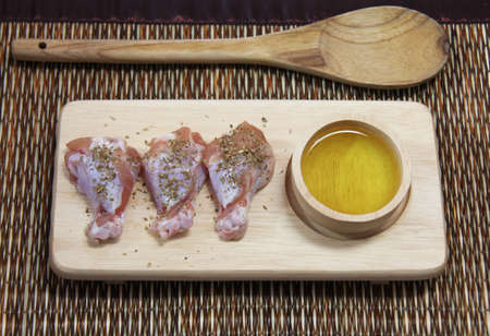 raw chicken on wooden boardの写真素材