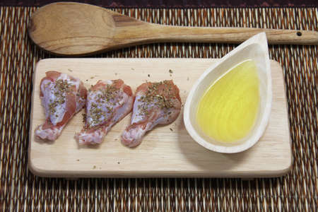 raw chicken on wooden boardの写真素材