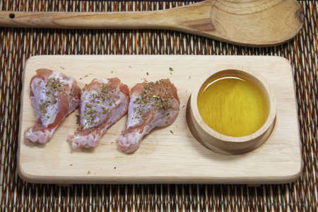 raw chicken on wooden boardの写真素材