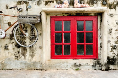 red old vintage window style and old bicycleの写真素材