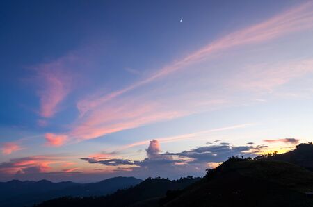 blue and orange sky from sunset at the mountain backgroundの写真素材