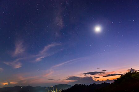 sunset background with moon and starsの写真素材