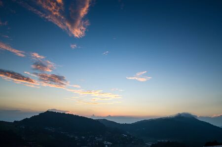 blue and orange sky from sunset at the mountain backgroundの写真素材