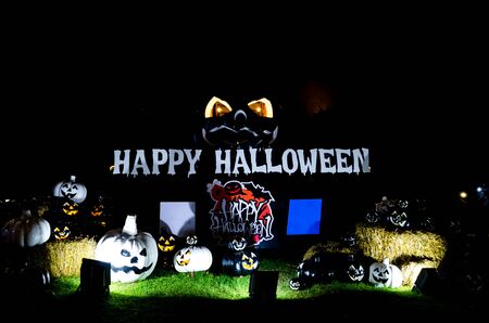 happy halloween letter and pumpkins at nightの写真素材