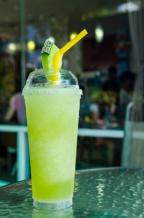 melon smoothie in glass on tableの写真素材