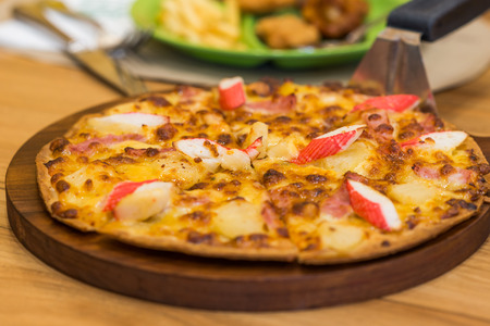 Delicious fresh pizza served on tableの写真素材