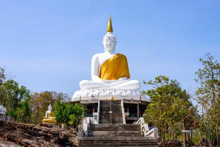 The white big Buddha statue on blue sky background in Thailandの写真素材