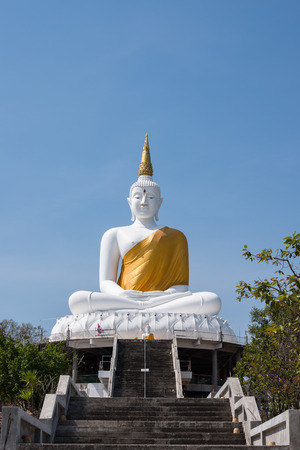The white big Buddha statue on blue sky background in Thailandの写真素材